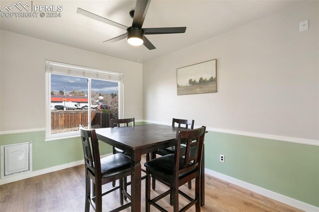 dining space featuring wood-type flooring and ceiling fan