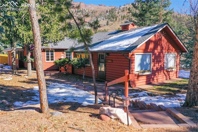 cabin featuring a mountain view