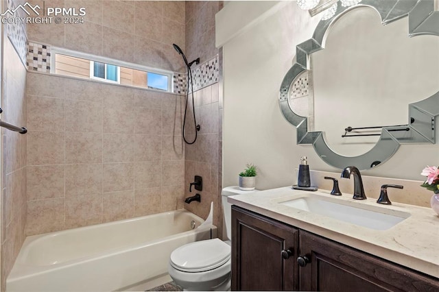 full bathroom with toilet, vanity, and tiled shower / bath