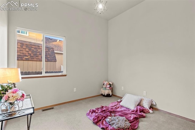 rec room featuring carpet and a notable chandelier