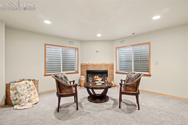 sitting room featuring carpet flooring and a fireplace