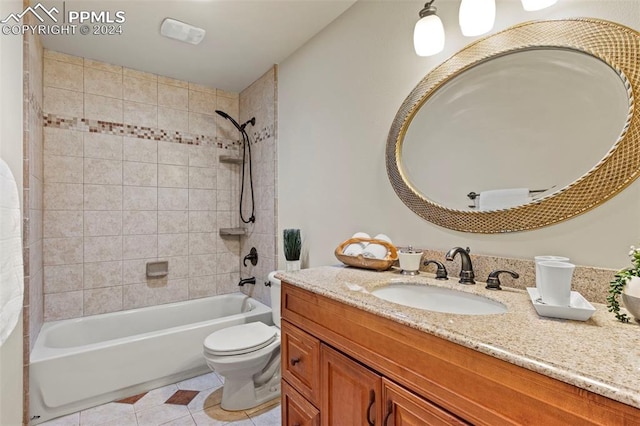 full bathroom featuring tile patterned floors, tiled shower / bath combo, toilet, and vanity