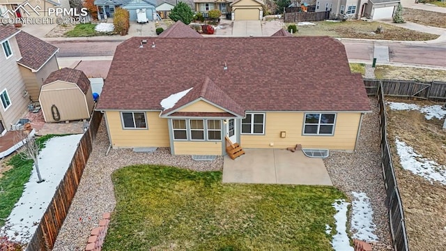 back of property with a patio area and a lawn