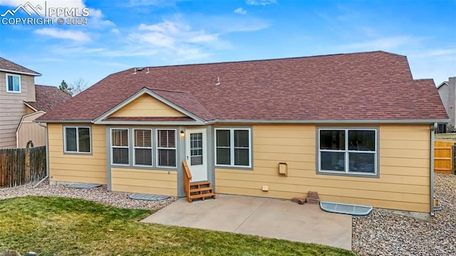 rear view of house with a lawn and a patio area