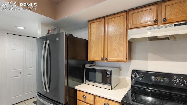 kitchen featuring appliances with stainless steel finishes and light tile patterned flooring