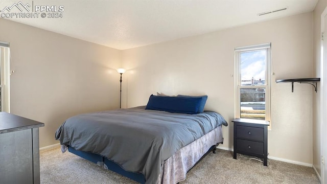 bedroom featuring light colored carpet