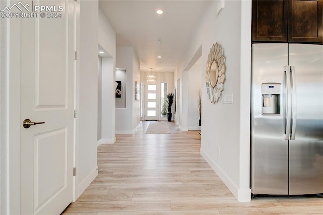 hallway with light hardwood / wood-style floors