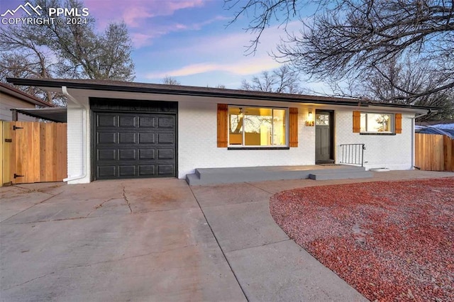 ranch-style house featuring a garage