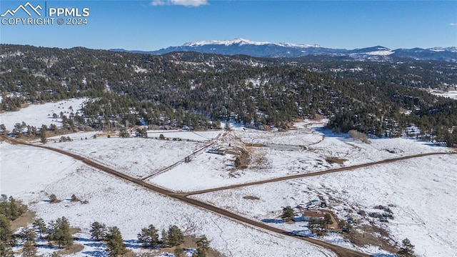 snowy aerial view featuring a mountain view