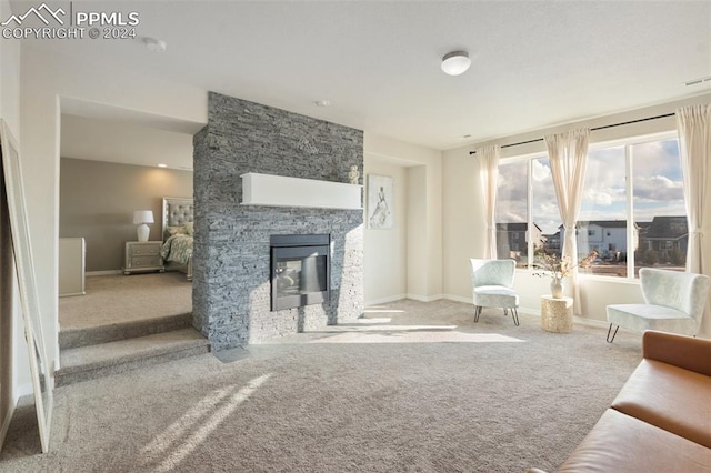 carpeted living room featuring a fireplace