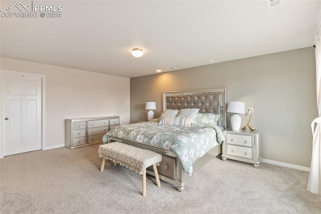 bedroom featuring light colored carpet