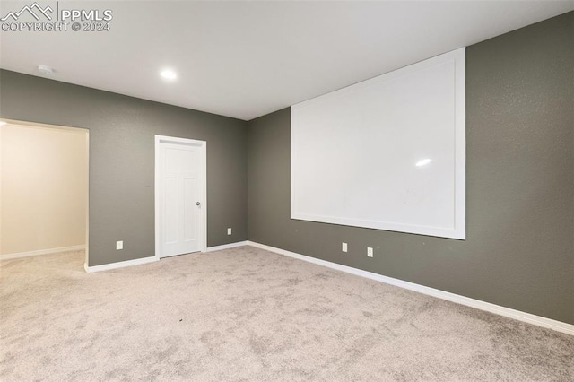 unfurnished room with light colored carpet