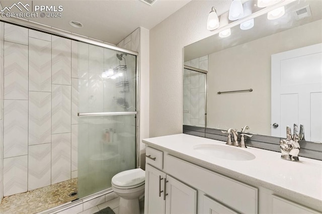 bathroom with vanity, toilet, and walk in shower