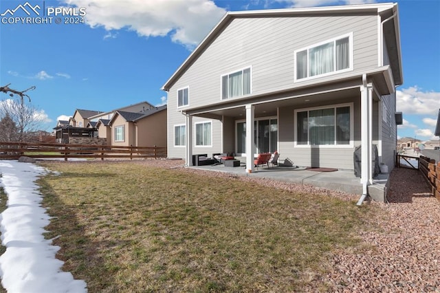 back of house featuring a lawn and a patio