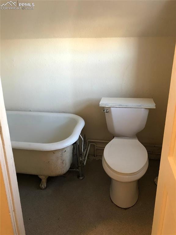 bathroom featuring toilet and a tub