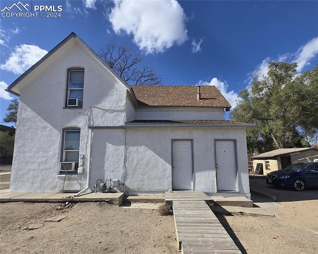 rear view of property featuring cooling unit