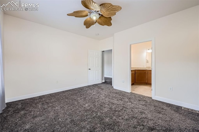 unfurnished bedroom featuring ceiling fan, carpet floors, and ensuite bath