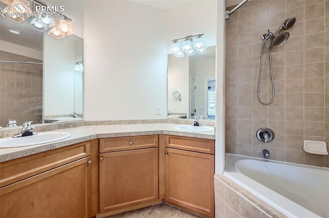 bathroom featuring tile patterned flooring, vanity, and tiled shower / bath combo