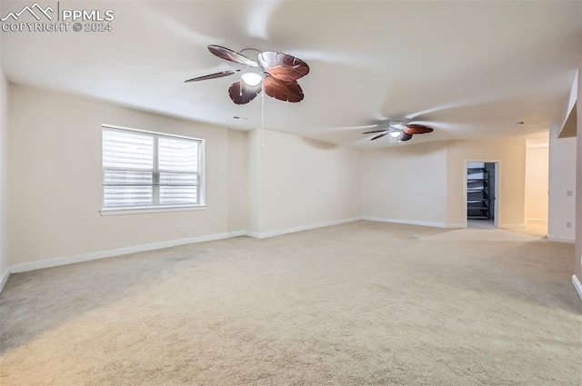 unfurnished room with ceiling fan and light colored carpet