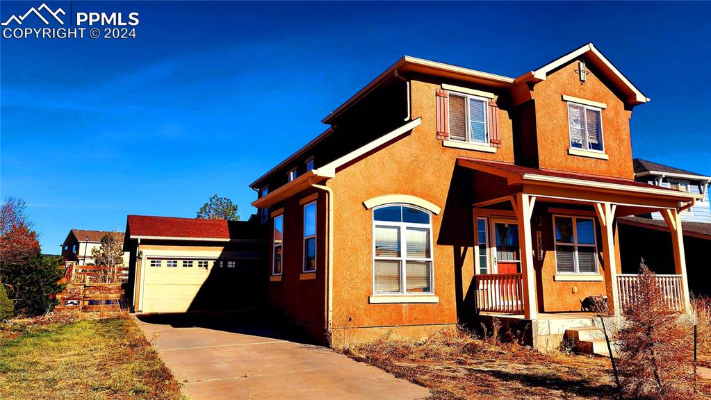 view of front of property featuring a garage and covered porch