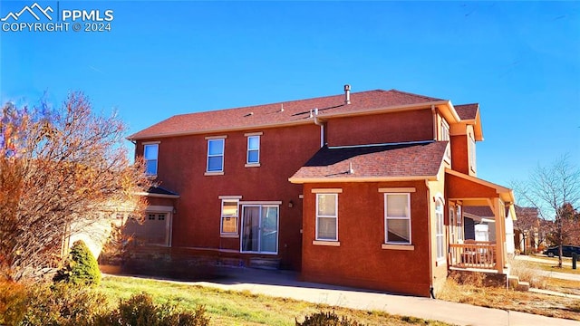 back of house with a garage