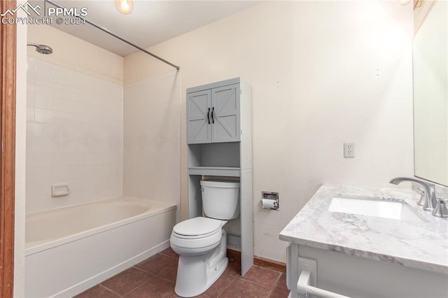 full bathroom featuring tiled shower / bath, tile patterned floors, vanity, and toilet