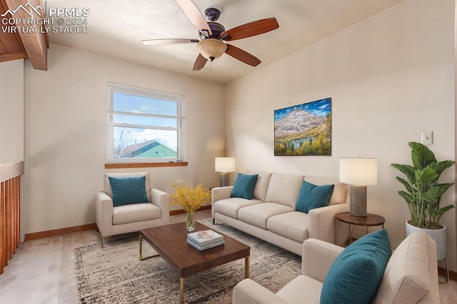 carpeted living room with beam ceiling and ceiling fan