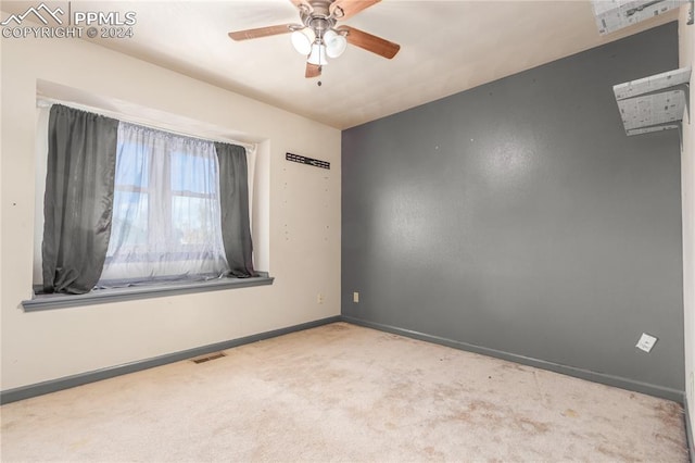 spare room featuring light carpet and ceiling fan