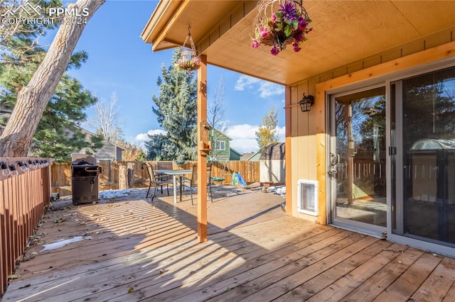 wooden deck featuring area for grilling