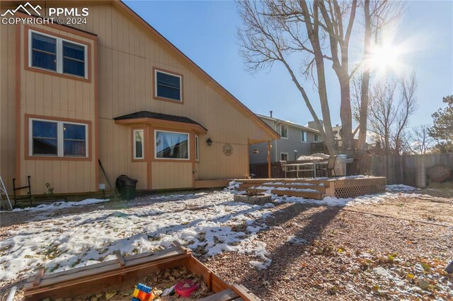 rear view of property with a wooden deck