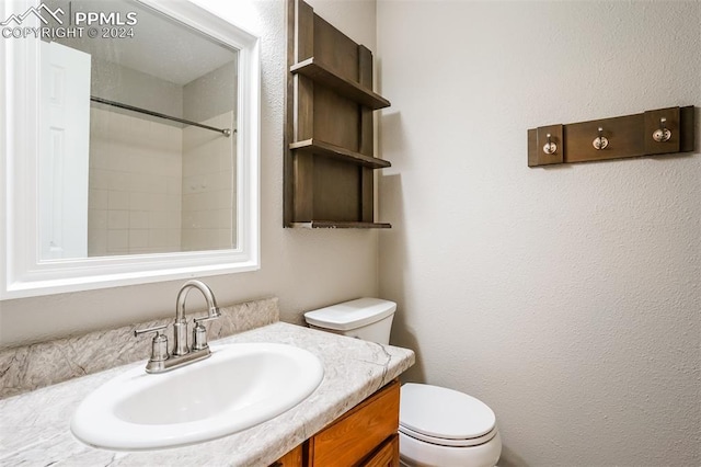 full bath with a shower, toilet, vanity, and a textured wall