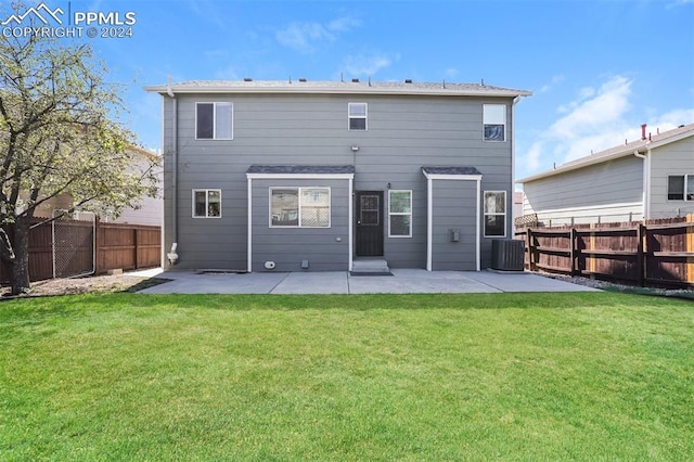 rear view of property featuring a patio, a yard, a fenced backyard, and central AC