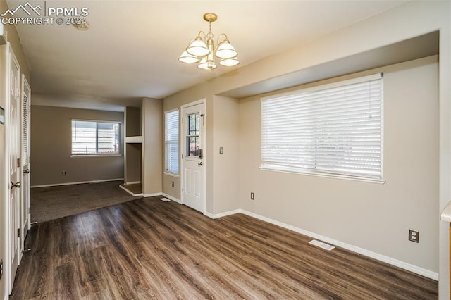 foyer entrance featuring visible vents, baseboards, an inviting chandelier, and dark wood-style flooring