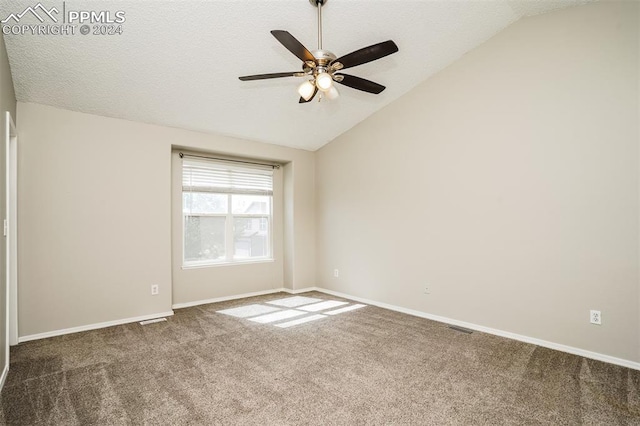 carpeted empty room with baseboards, visible vents, a textured ceiling, and lofted ceiling