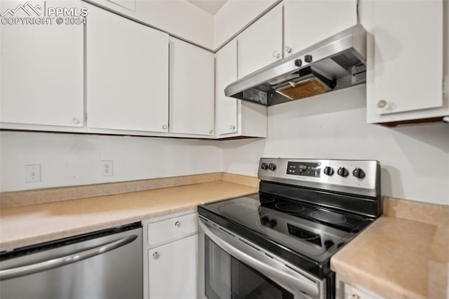 kitchen featuring stainless steel appliances and white cabinetry