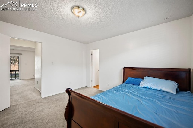 carpeted bedroom with a textured ceiling