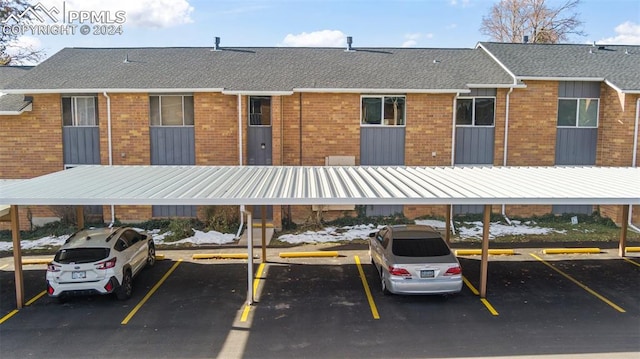 view of parking / parking lot featuring a carport