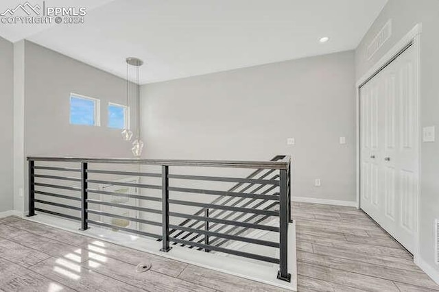 stairway with hardwood / wood-style floors