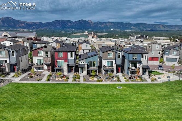 exterior space featuring a mountain view and a lawn