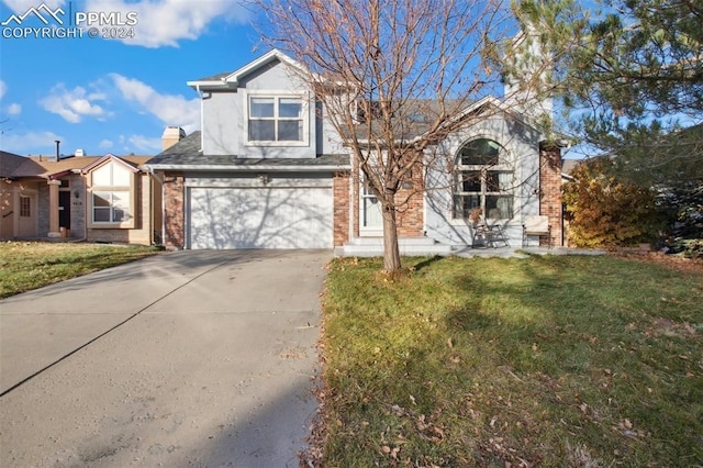 view of front of property with a garage and a front yard