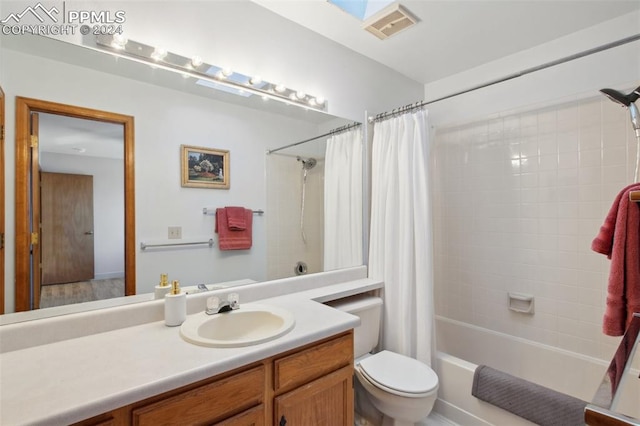 full bathroom featuring vanity, toilet, and shower / bathtub combination with curtain