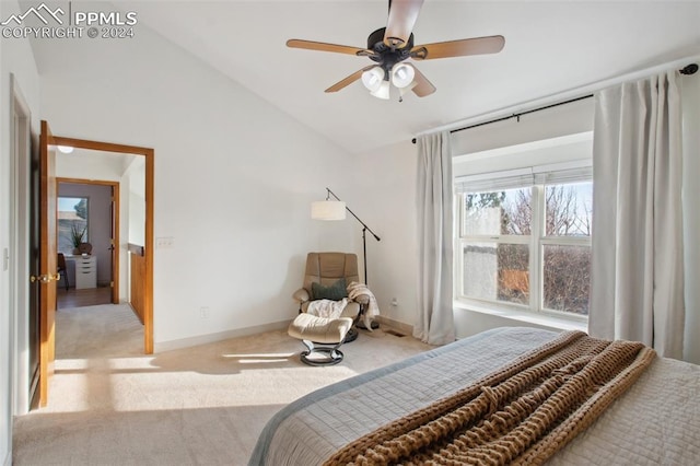 bedroom featuring light colored carpet, vaulted ceiling, and ceiling fan