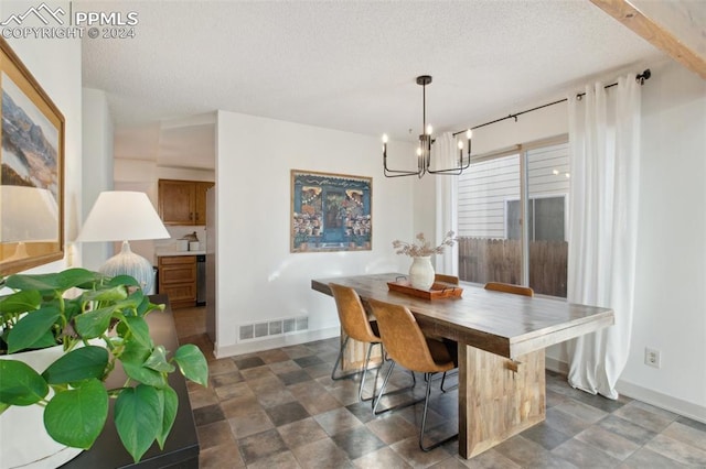 dining area with beam ceiling, a textured ceiling, and a notable chandelier