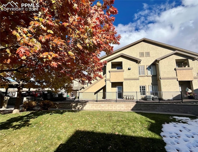 rear view of house with a lawn