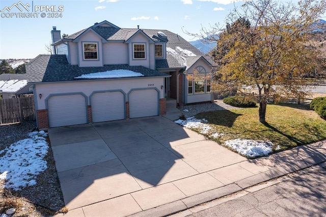 front facade featuring a garage and a front lawn