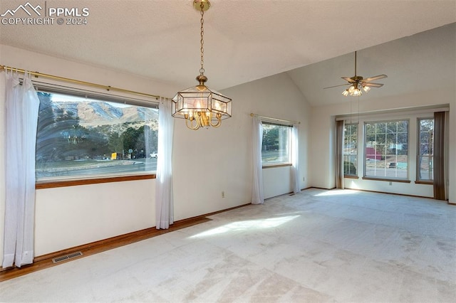 unfurnished room with carpet, ceiling fan with notable chandelier, and lofted ceiling