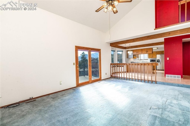 unfurnished living room with carpet, ceiling fan, beamed ceiling, and high vaulted ceiling