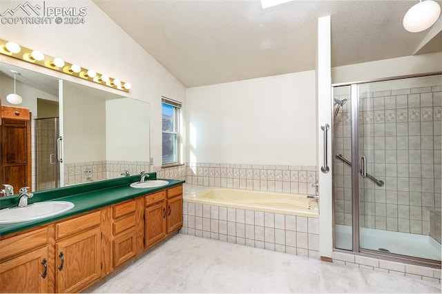 bathroom with vanity, independent shower and bath, and lofted ceiling