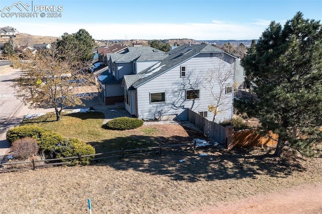 view of property exterior with a lawn