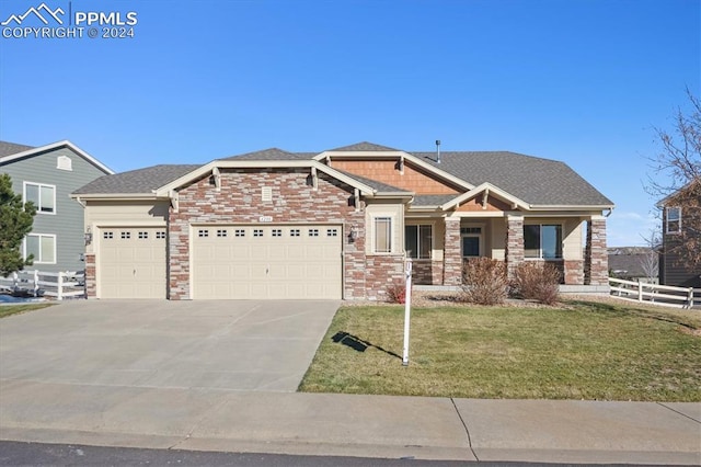 craftsman house with a front yard and a garage